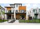 Contemporary two-story home featuring wood accents, modern balconies, and a manicured front yard offers stylish curb appeal at 340 Milwaukee St, Denver, CO 80206