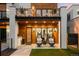 Welcoming front porch with decorative hanging chairs and modern wood-and-glass door at 340 Milwaukee St, Denver, CO 80206