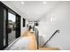 Bright hallway with hardwood floors, an adjacent entertainment area, and staircase access to other levels of the home at 340 Milwaukee St, Denver, CO 80206