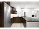 Modern kitchen with stainless steel appliances, sleek countertops, and custom cabinetry and shelving at 340 Milwaukee St, Denver, CO 80206