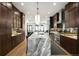 Modern kitchen features an expansive marble island and stylish dark wood cabinetry at 340 Milwaukee St, Denver, CO 80206