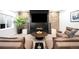 Cozy living room with a stone accent wall, a modern fireplace, comfortable seating, and a large television at 340 Milwaukee St, Denver, CO 80206