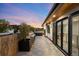 Relaxing outdoor patio featuring tile floors, an outdoor bar, and seating area with views of the surrounding neighborhood at 340 Milwaukee St, Denver, CO 80206