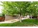 Spacious backyard with mature trees and a patio area perfect for outdoor entertaining at 1317 S Saint Paul St, Denver, CO 80210
