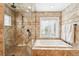 Bright bathroom featuring a separate shower, soaking tub, and window with natural light at 1317 S Saint Paul St, Denver, CO 80210