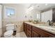 Bathroom featuring a granite countertop, double vanity, and tile backsplash at 1317 S Saint Paul St, Denver, CO 80210