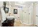 Bathroom featuring an ornate vanity, decorative bowl sink, tiled floors, and glass shower at 1317 S Saint Paul St, Denver, CO 80210