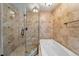 Tiled bathroom showing bathtub and glass shower featuring neutral colored tile, and modern fixtures at 1317 S Saint Paul St, Denver, CO 80210