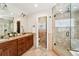 Bathroom featuring double vanity, granite counters, tiled shower, and separate toilet room at 1317 S Saint Paul St, Denver, CO 80210