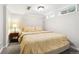 Bright bedroom featuring neutral carpet and walls, tufted headboard, side table, and natural light from the window at 1317 S Saint Paul St, Denver, CO 80210