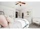 Bright bedroom with white walls, ceiling fan, closet, and cozy white chair at 1317 S Saint Paul St, Denver, CO 80210