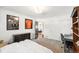 Bright bedroom featuring neutral carpet, a study desk, and a walk-in closet with direct access to an adjacent space at 1317 S Saint Paul St, Denver, CO 80210