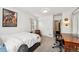 Bright bedroom featuring plush carpet, a study desk, neutral walls, and natural light from the window at 1317 S Saint Paul St, Denver, CO 80210
