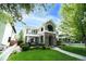 Charming home with manicured lawn, lush greenery, and inviting facade in a desirable neighborhood at 1317 S Saint Paul St, Denver, CO 80210