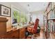Inviting home office with wood desk, large windows, and a bookshelf at 1317 S Saint Paul St, Denver, CO 80210