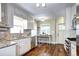 Bright kitchen with stainless steel appliances, granite countertops, breakfast bar, and convenient access to the outdoors at 1317 S Saint Paul St, Denver, CO 80210