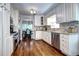Charming kitchen with stainless appliances, granite countertops, white cabinets, and hardwood floors; great layout! at 1317 S Saint Paul St, Denver, CO 80210