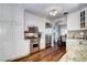 Kitchen showcases stainless steel Wolf range, microwave, refrigerator, and custom cabinets with hardwood floors at 1317 S Saint Paul St, Denver, CO 80210