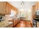 Kitchen with stainless steel appliances, granite counters, and wood cabinets at 1317 S Saint Paul St, Denver, CO 80210