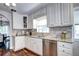 Well-lit kitchen features white cabinets, stainless steel appliances, granite countertops, and hardwood floors at 1317 S Saint Paul St, Denver, CO 80210