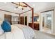 Comfortable main bedroom with a four-poster bed, wood doors and an ensuite bathroom at 1317 S Saint Paul St, Denver, CO 80210