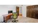 Home office space with wood desk, carpet, and dark wood doors and trim at 1317 S Saint Paul St, Denver, CO 80210