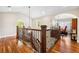 An elegant staircase featuring hardwood floors, wood treads, dark metal spindles, and an adjacent study at 1317 S Saint Paul St, Denver, CO 80210