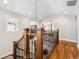 An elegant staircase featuring wood treads, dark metal spindles, and natural light from the window at 1317 S Saint Paul St, Denver, CO 80210