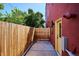 The backyard has a wooden fence, side door, and concrete ground at 3943 W 12Th Ave, Denver, CO 80204