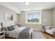 Bright bedroom featuring hardwood floors, a large window, and tasteful decor with a gray color scheme at 3943 W 12Th Ave, Denver, CO 80204