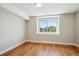 Bright bedroom featuring hardwood floors, a large window, and neutral paint at 3943 W 12Th Ave, Denver, CO 80204