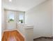 Hallway leading to stairs with hardwood floors, neutral paint, and white trim at 3943 W 12Th Ave, Denver, CO 80204