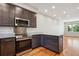 Kitchen includes stainless steel appliances, modern cabinetry, stone countertops, and hardwood floors at 3943 W 12Th Ave, Denver, CO 80204