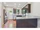 Modern kitchen featuring granite counters, stainless steel appliances, and dark cabinetry at 3943 W 12Th Ave, Denver, CO 80204
