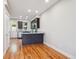 Eat-in kitchen with dark cabinets, stainless steel appliances, and hardwood floors at 3943 W 12Th Ave, Denver, CO 80204