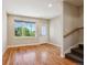 Open concept living room with hardwood flooring and a large window for ample natural light at 3943 W 12Th Ave, Denver, CO 80204