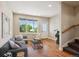 Bright living room featuring hardwood floors, a large window, and modern furnishings at 3943 W 12Th Ave, Denver, CO 80204