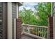 View from the balcony overlooking a quaint neighborhood with brick pillars and a wood railing at 9165 Kornbrust Dr, Lone Tree, CO 80124