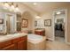 Luxurious bathroom with double vanity, soaking tub, and access to a walk-in closet at 9165 Kornbrust Dr, Lone Tree, CO 80124