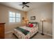 Comfortable bedroom with floral bedding, shuttered windows, and ample lighting, creating a cozy space at 9165 Kornbrust Dr, Lone Tree, CO 80124