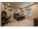 Spacious bedroom with a dark-colored bed, desk, neutral walls, and a window for natural light at 9165 Kornbrust Dr, Lone Tree, CO 80124