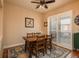 Cozy dining area featuring a wooden table set, ceiling fan, and sliding glass door to the outside at 9165 Kornbrust Dr, Lone Tree, CO 80124