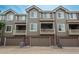 Townhome complex with attached garages, upper-level balconies, and neutral color scheme at 9165 Kornbrust Dr, Lone Tree, CO 80124