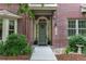 Close-up of the charming brick home showcasing the front door and well-maintained landscaping at 9165 Kornbrust Dr, Lone Tree, CO 80124