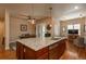 Elegant kitchen island with stone countertops, stainless steel appliances, and pendant lighting at 9165 Kornbrust Dr, Lone Tree, CO 80124