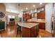 Kitchen features an island with barstool seating, stainless steel appliances, and hardwood floors at 9165 Kornbrust Dr, Lone Tree, CO 80124