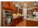 Well-equipped kitchen with stainless steel appliances, custom cabinets, and granite countertops at 9165 Kornbrust Dr, Lone Tree, CO 80124