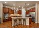 Spacious kitchen boasts a large island, stainless steel appliances, and warm wood cabinetry at 9165 Kornbrust Dr, Lone Tree, CO 80124