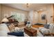 Comfortable living room featuring hardwood floors, stylish seating, and a grand piano at 9165 Kornbrust Dr, Lone Tree, CO 80124