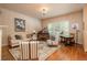 Bright living room with hardwood floors, large windows, and an upright piano at 9165 Kornbrust Dr, Lone Tree, CO 80124